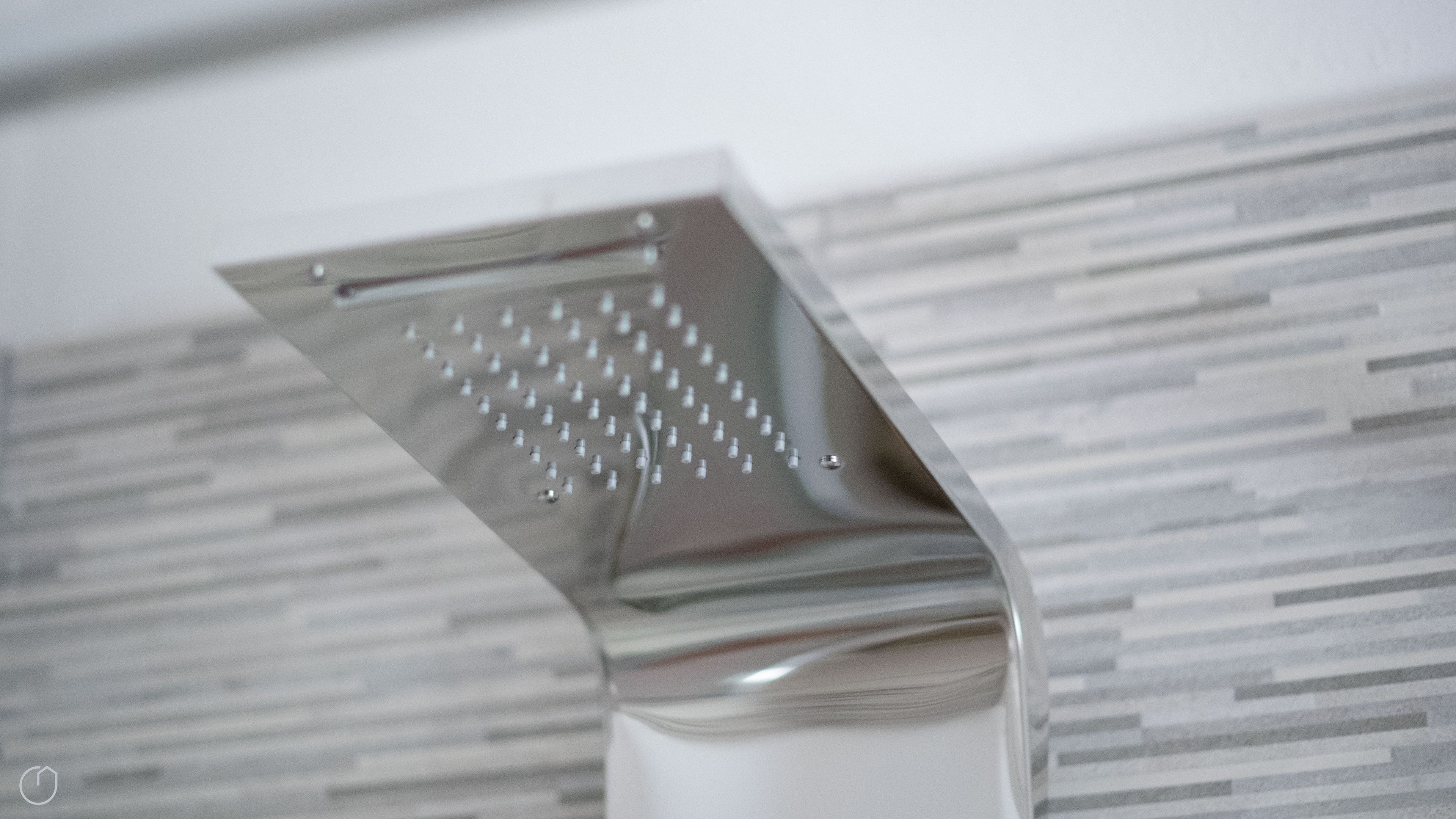 A metallic, reflective object with a grid pattern, likely a part of a modern interior design.