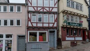 A traditional half-timbered building with a shop on the ground floor.