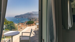 A balcony with a view of the sea and mountains, a table, and two chairs. - Villa Sacco - Sorrento Coast (Priora)
