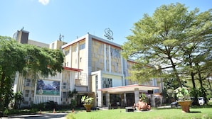 A hotel with a modern facade, a covered entrance, and a large sign. -  LORIN SYARIAH HOTEL SENTUL (Bogor)