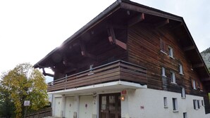 A two-story building with a wooden facade and a balcony.