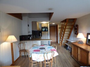 Enjoy meals at the dining table in this kitchen with a central island and modern appliances.
