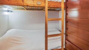 A bunk bed with a wooden ladder, a white mattress, and a wooden dresser with multiple drawers. - Cozy 1BR+Alcove in Serre Chevalier with Pool, WiFi, Private Parking, Near Slopes (Saint-Chaffrey)