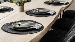 A long dining table with black placemats, plates, and cutlery. - Spacious + Stylish Home w/HotTub 12min to Downtown (Westminster)