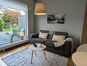 Apartment, 1 Bedroom | Living area | 47-inch flat-screen TV with cable channels