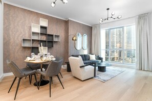 Design Apartment | Living area | 65-inch Smart TV with cable channels - Nasma Holiday Homes - The Torch Tower 1 (Dubai)