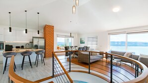 A modern interior with a kitchen, dining area, and living room.