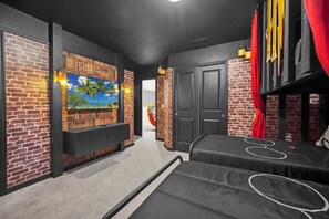 A room with brick walls, a mural, a black door, and a red curtain. - Harry Potter | LEGO Arcade | Avengers | Disney 4297 (Davenport)