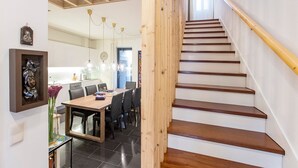 Eine Treppe mit Holzboden und Handlauf, die zu einer oberen Etage führt.