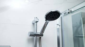 Shower, hair dryer, towels, shampoo