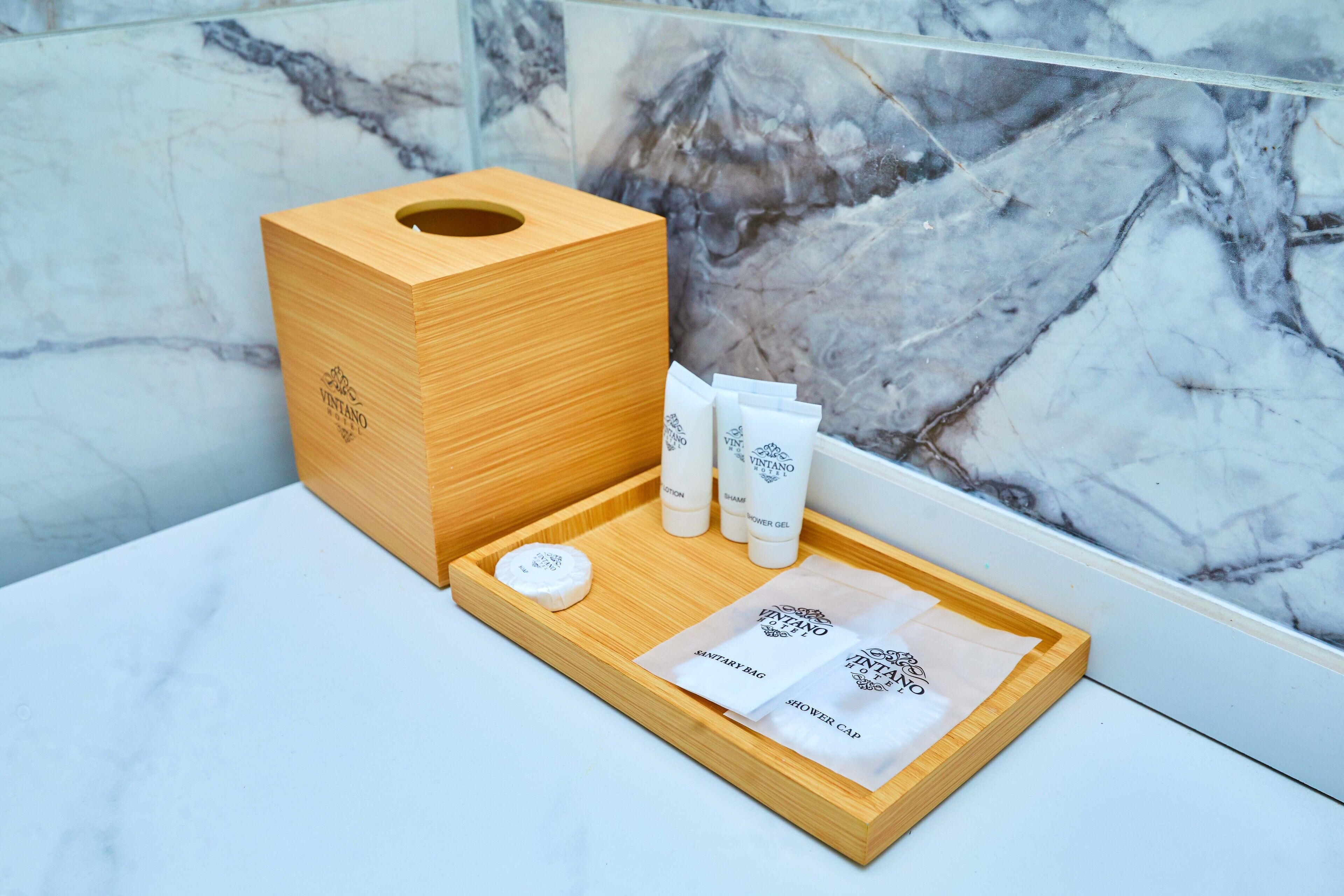 A wooden toiletry box with a marble background.