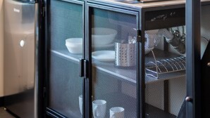 A compact kitchenette with a microwave, toaster, kettle, and a small refrigerator. - Motto Gdańsk (Gdansk)