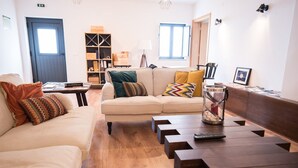 Una sala de estar con un sofá, una mesa de centro y una estantería.