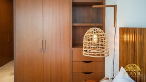 A wooden wardrobe with a hanging wicker light fixture and a wooden headboard. - NHOA 108B Lux 1BR Condo Plunge Pool in Aldea Zama (Tulum)