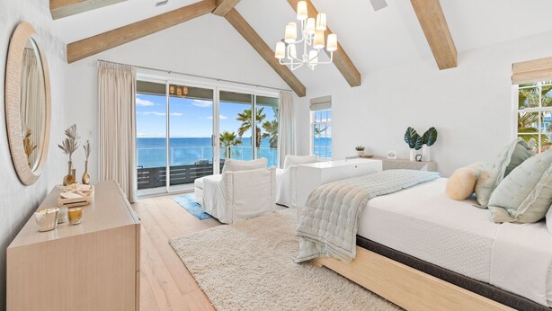 A spacious bedroom with a large bed, a desk, and a view of the ocean. - 2590 E County Highway 30a 7 Bedroom Home by RedAwning (Santa Rosa Beach)