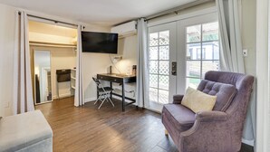 A room with a desk, a chair, a sofa, and a TV. - 5 Mi to Dtwn: Pet-friendly Phoenix Studio w/ Yard (Phoenix)