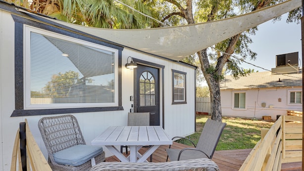 A covered outdoor seating area with a table and chairs, a door, and a window. - Modern Tiny Home ~ 5 Mi to Downtown Phoenix! (Phoenix)