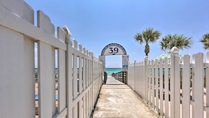 A pathway leading to a beach entrance with a sign reading "39" and palm trees on the right. - Walk to Beach + Restaurants: PCB Resort Condo! (Panama City Beach)