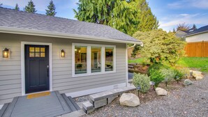 A house with a dark front door, large windows, and a small porch. - Private Yard & Fire Pit! Modern Kirkland Abode (Kirkland)