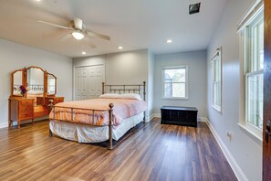 A bedroom with a bed, dresser, mirror, and a ceiling fan. - Spacious & Inviting Jackson Getaway w/ Fireplace! (Jackson)
