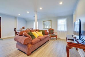 A living room with a sofa, chairs, a TV, and a dining table. - Spacious & Inviting Jackson Getaway w/ Fireplace! (Jackson)