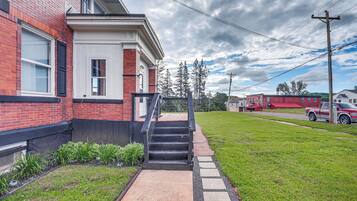 Stunning suburban home with a charming garden and black stairs leading to the front door.