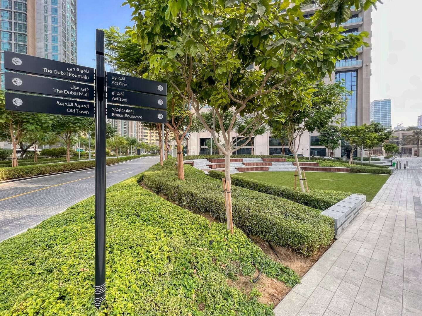 A signpost with directions to The Dubai Fountain, The Dubai Mall, Old Town, and Emaar Boulevard.