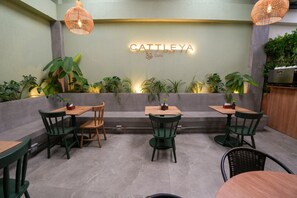 Relax in a serene outdoor dining space with a planter and comfortable seating.