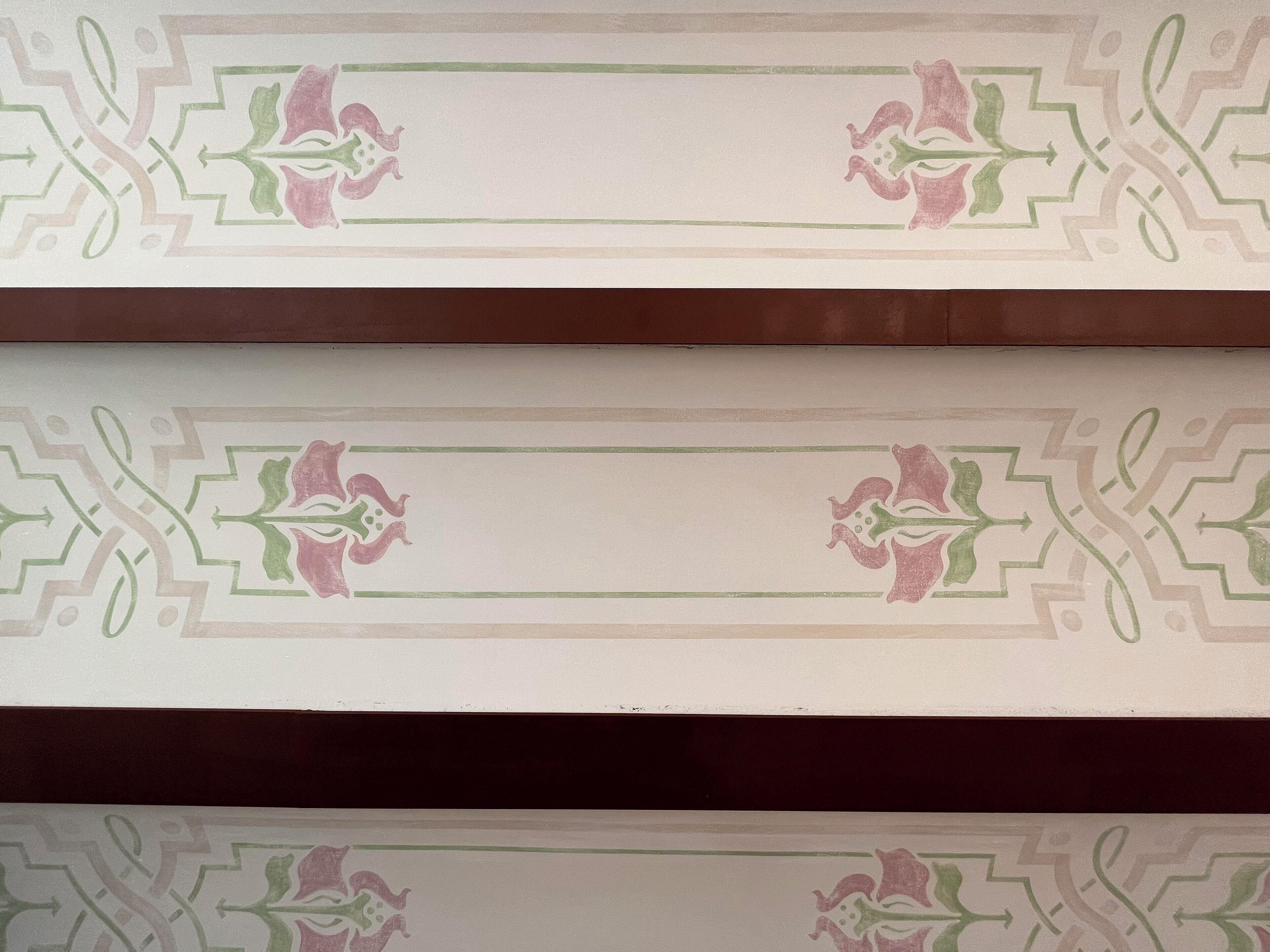 A patterned wall with a central rectangular space, likely for a sign or decoration.