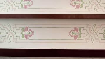 A patterned wall with a central rectangular space, likely for a sign or decoration.