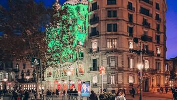 A building with a green-lit facade and a traditional European architectural style.