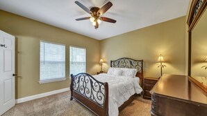 A bedroom with a bed, two bedside lamps, a ceiling fan, and a dresser. - 30A Getaway Too! (Santa Rosa Beach)