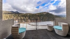 A balcony with wicker furniture and a view of a forested mountain range. - Dandy’s Ranch.
Dream Mountain Home! (Morrison)