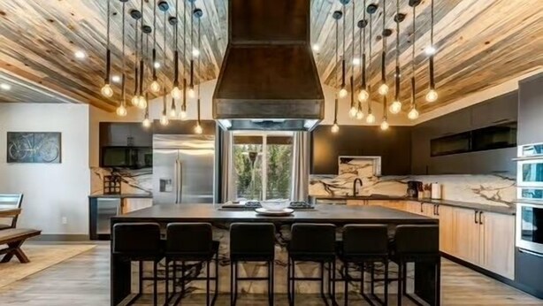 A modern kitchen with a central island, bar stools, and pendant lighting. - Dandy’s Ranch.
Dream Mountain Home! (Morrison)