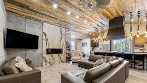 A modern living room with leather sofas, a flat-screen TV, and a wooden ceiling. - Dandy’s Ranch.
Dream Mountain Home! (Morrison)