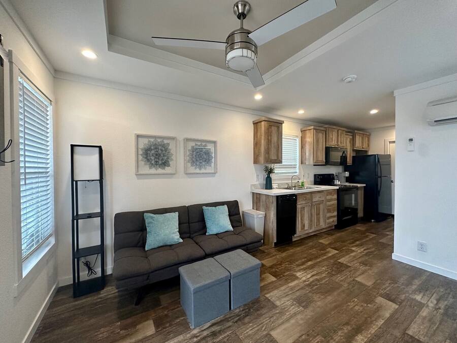 A modern kitchen with wooden cabinets, a built-in oven, and a refrigerator.