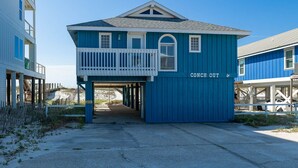 A blue building with a balcony and a sign reading "CONCH OUT". - Conch Out 1405 | Gulf-Front Beach House (Gulf Shores)