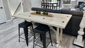 A dining area with a wooden table, black stools, and a decorative tray with green spheres. - STAY HERE! 2 Homes sleep up to 28! Private cove 2 docks and personal boat launch (Sevierville)