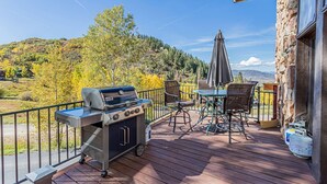 A patio with a grill, outdoor furniture, and a scenic view. - Private Luxury Mountain Estate w/ Views & Hot Tub (Steamboat Springs)