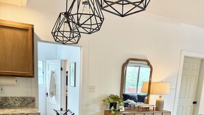 A kitchen with a granite countertop, stainless steel sink, and pendant lighting. - Spacious 3 Bedroom Home with yard, pet friendly & sleeps 6! (Oroville)