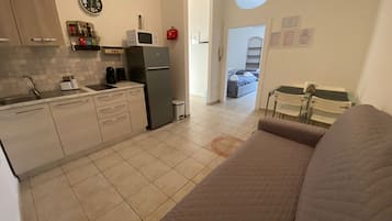 Comfort Apartment | Private kitchen | Full-sized fridge, microwave, stovetop, cookware/dishes/utensils
