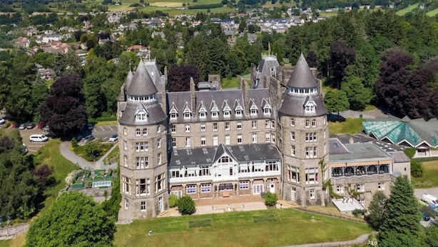 A large, historic castle with multiple towers and a central courtyard.