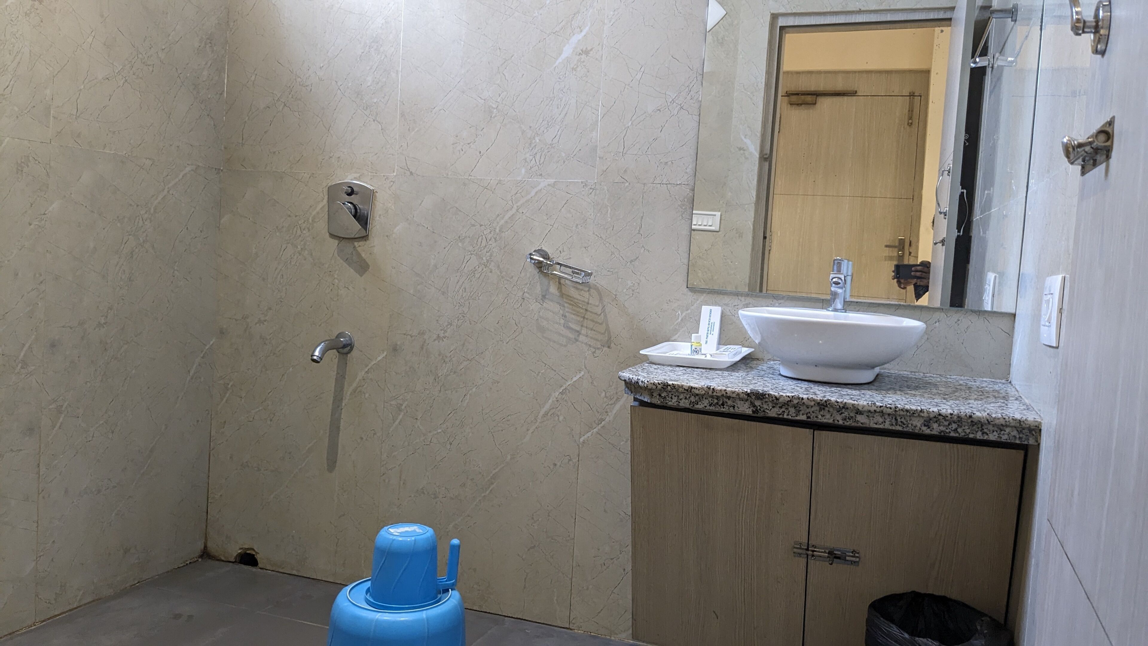 A bathroom with a shower, sink, and mirror.