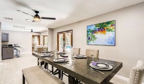 Enjoy meals in this dining area with a long table and comfortable chairs.