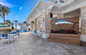 Relax in the resort's spacious outdoor seating area with a clear view of the surrounding palm trees.