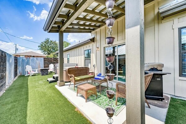 A patio with outdoor furniture, a grill, and a pergola. - The Ricardo (Fredericksburg)