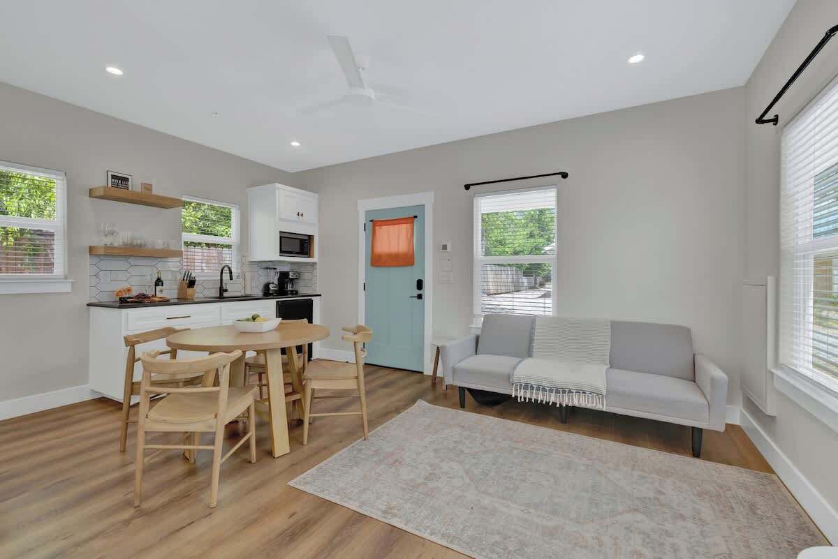 A modern apartment with a kitchen, dining area, and living room.