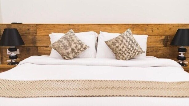 A bed with white linens, two patterned pillows, and a woven throw. - Suffix Retreat - Stay, Dive & Explore Fuvahmulah (Fuvahmulah)