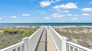 A wooden boardwalk leading to a beach with a clear sky. - 4BR Ocean Front - Dogs OK! (Emerald Isle)