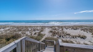 A wooden boardwalk leading to a beach with a clear view of the ocean and sandy dunes. - 4BR Ocean Front - DOG OK - Close to town! (Emerald Isle)